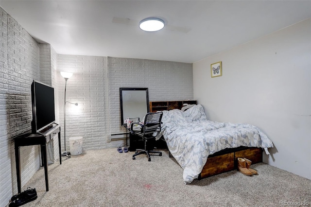 carpeted bedroom with brick wall and baseboard heating