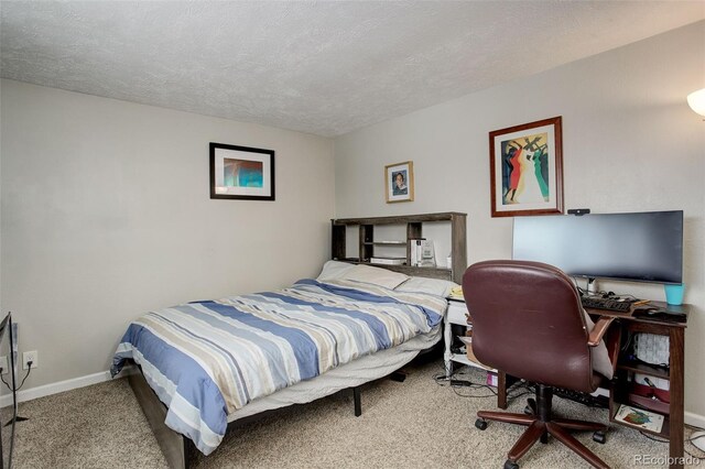 carpeted bedroom featuring a textured ceiling