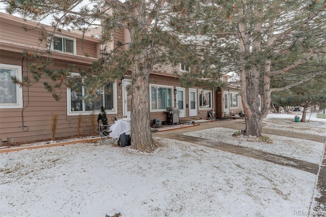 view of snow covered back of property