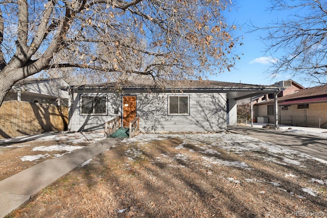 rear view of property with a carport