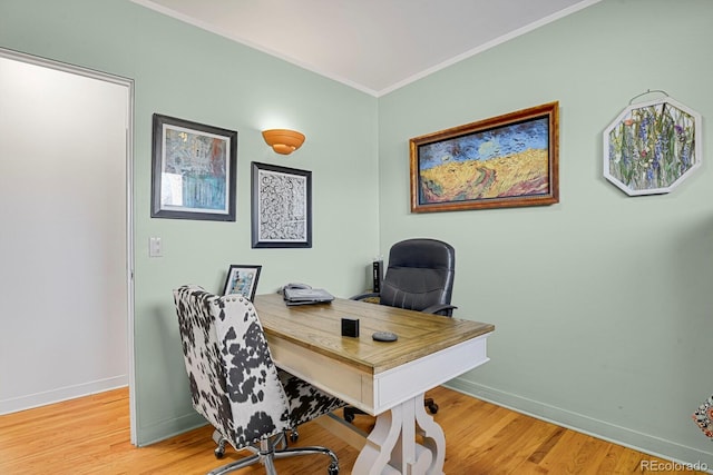 office with ornamental molding and light hardwood / wood-style flooring