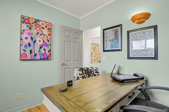 office space with ornamental molding and light hardwood / wood-style flooring