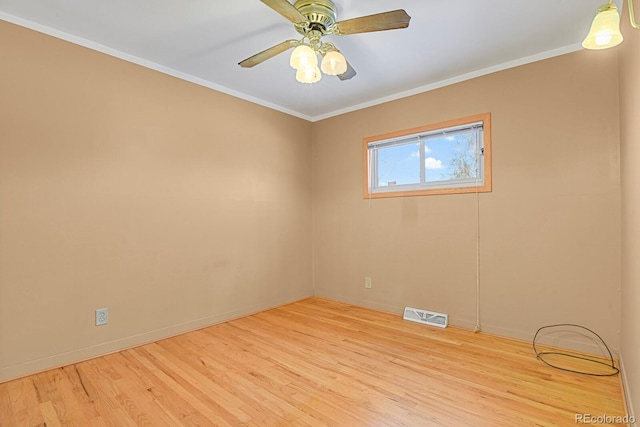 empty room featuring crown molding, ceiling fan, and light wood-type flooring