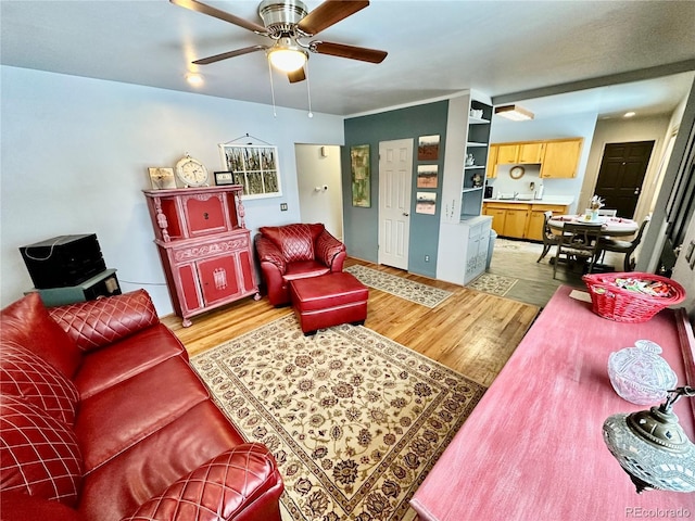 living room with ceiling fan and light wood finished floors