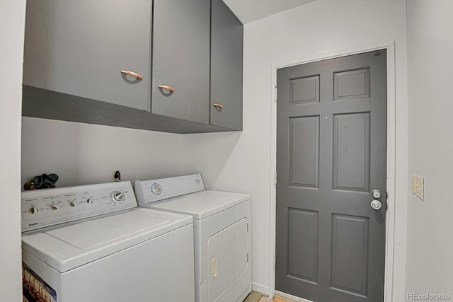 laundry area with cabinet space and separate washer and dryer