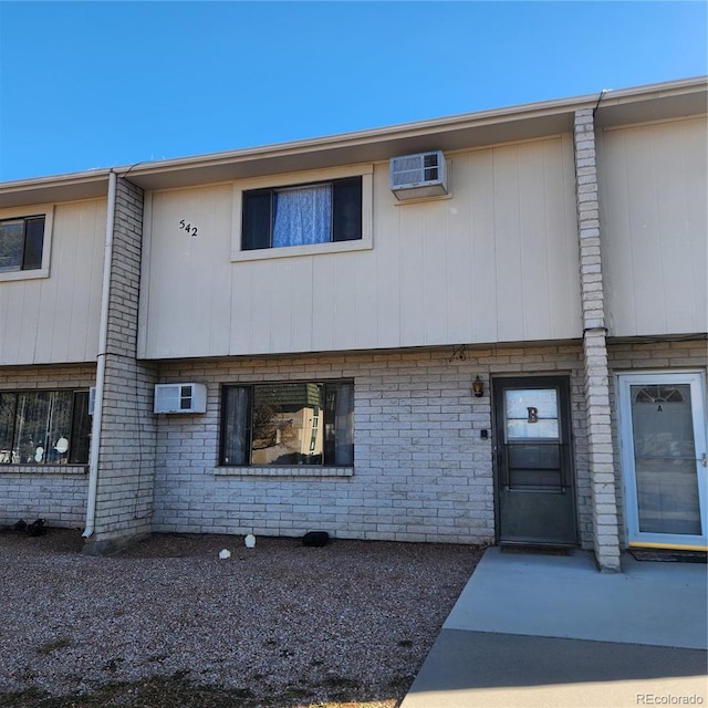 view of property with a wall mounted AC