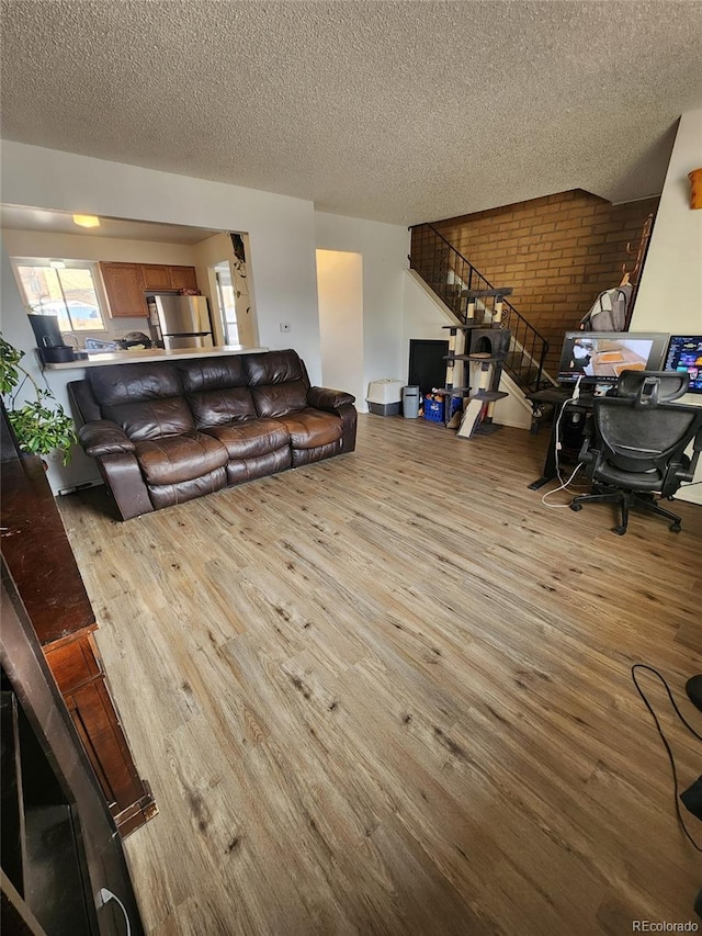 living room with light hardwood / wood-style flooring and a textured ceiling