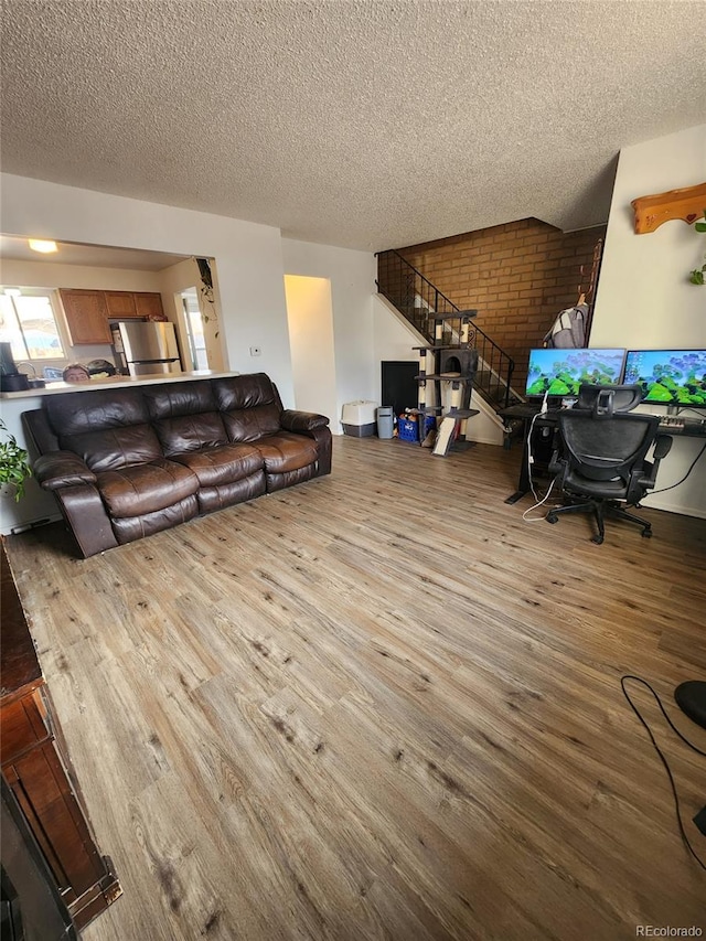 living room with a textured ceiling and hardwood / wood-style flooring