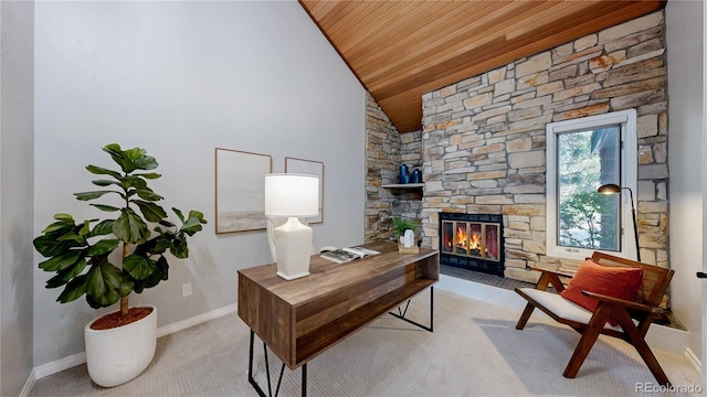 carpeted office space featuring wooden ceiling, lofted ceiling, a stone fireplace, and baseboards