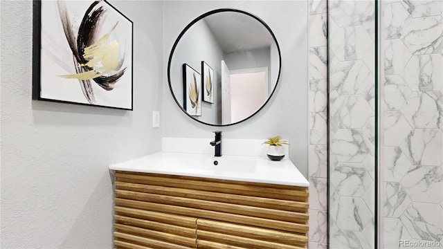 bathroom with vanity and a textured wall
