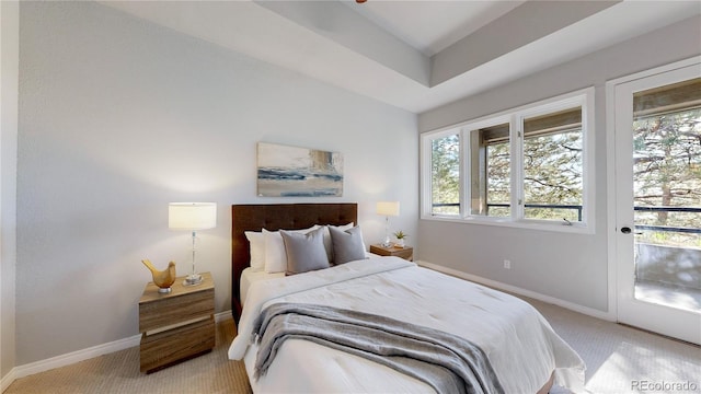 bedroom featuring light carpet, multiple windows, and baseboards