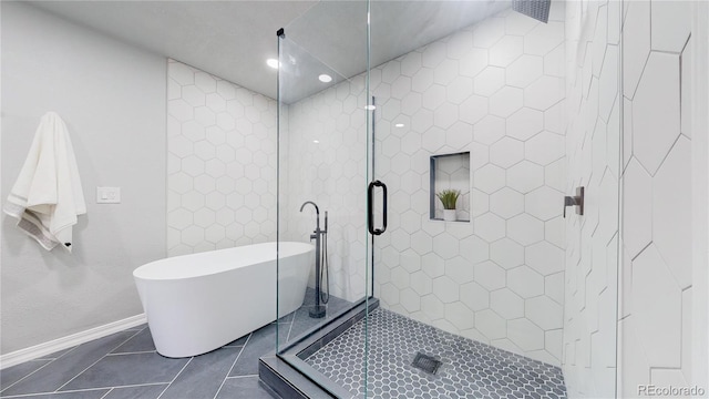 bathroom with a soaking tub, tile patterned flooring, baseboards, a stall shower, and recessed lighting