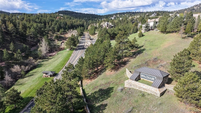 aerial view of property's location with a heavily wooded area