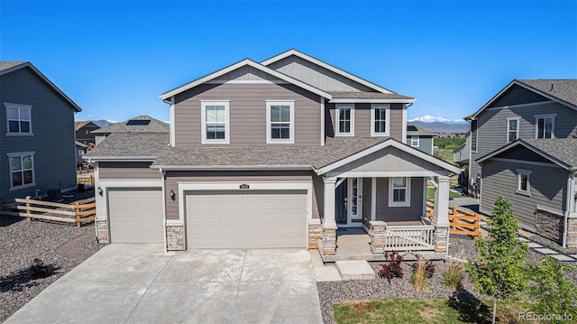 1953 Morgan Dr, Erie, CO 80516 - craftsman-style house featuring a porch, a shingled roof, concrete driveway, a garage, and stone siding
