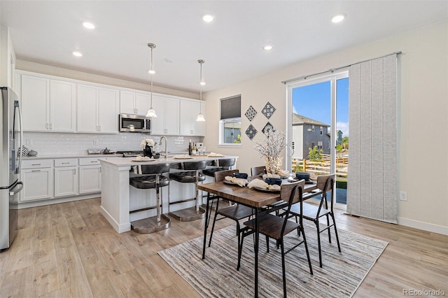 1953 Morgan Dr, Erie, CO 80516 - dining area featuring light wood finished floors, recessed lighting, and baseboards