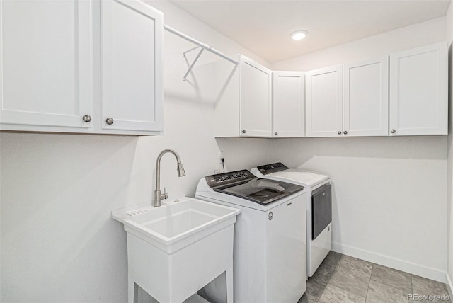 1953 Morgan Dr, Erie, CO 80516 - washroom featuring washer and clothes dryer, cabinet space, and baseboards