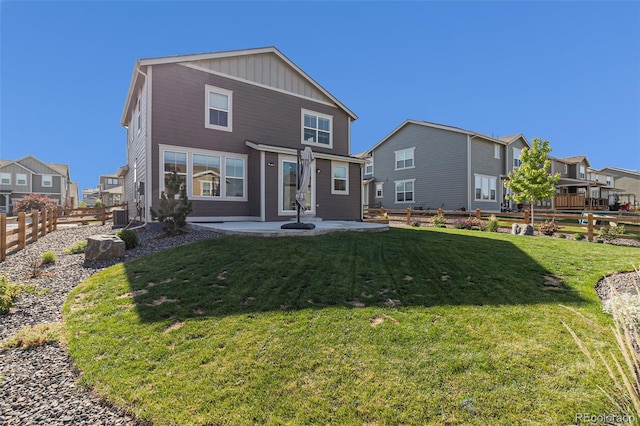1953 Morgan Dr, Erie, CO 80516 - back of property with a patio area, board and batten siding, a residential view, and central AC unit