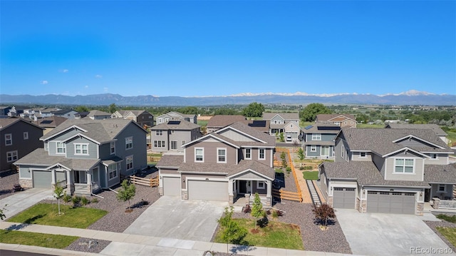 1953 Morgan Dr, Erie, CO 80516 - view of front of house with concrete driveway, a residential view, a garage, and stone siding
