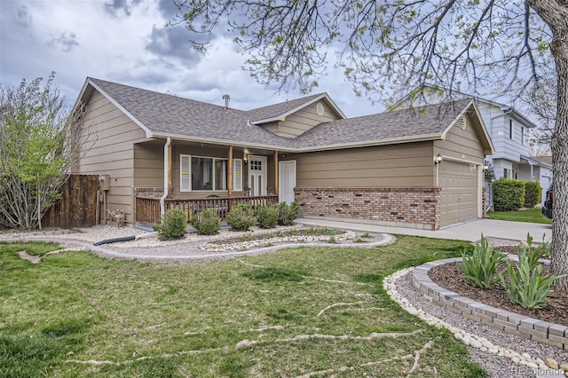 ranch-style home featuring covered porch, a garage, and a front yard