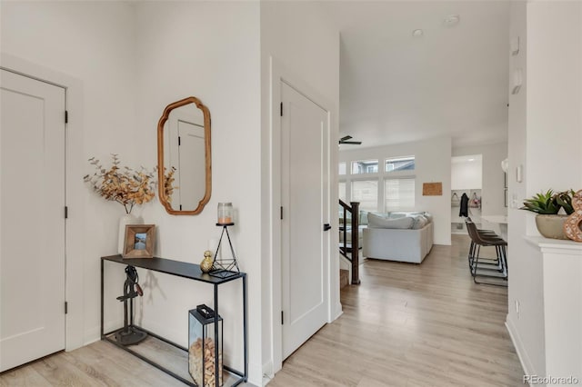 entrance foyer with baseboards and light wood-style flooring