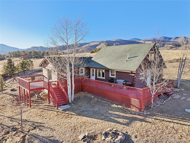 rear view of house featuring a deck with mountain view