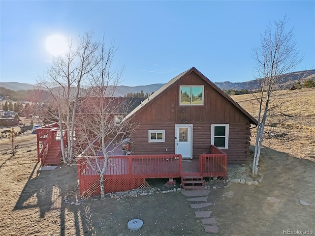 rear view of property with a deck with mountain view