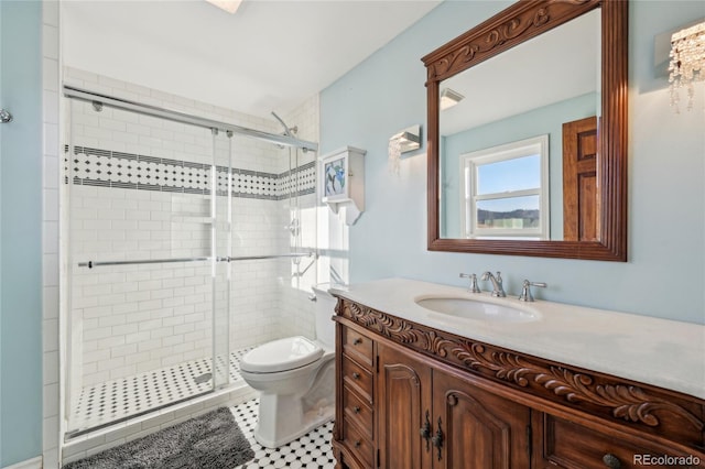 bathroom with an enclosed shower, toilet, tile patterned floors, and vanity