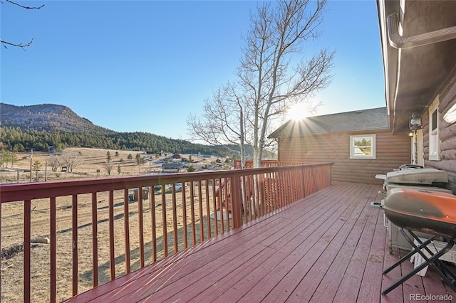 wooden terrace with a mountain view and area for grilling