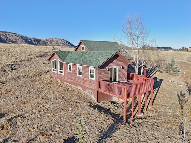 back of house with a deck with mountain view