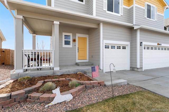 property entrance featuring fence, driveway, covered porch, and an attached garage
