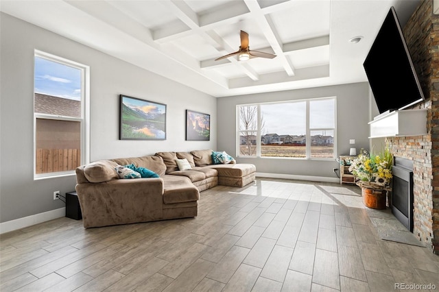 living room with baseboards, a fireplace, wood finished floors, a ceiling fan, and coffered ceiling