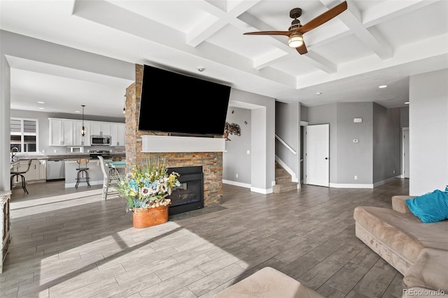 living room featuring beamed ceiling, baseboards, ceiling fan, wood finished floors, and coffered ceiling