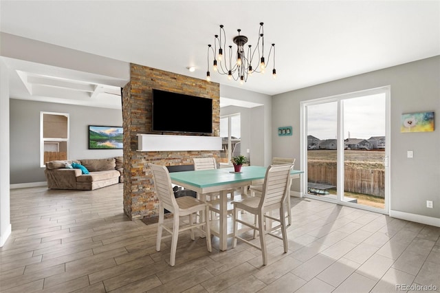 dining room featuring a notable chandelier, coffered ceiling, baseboards, and wood tiled floor