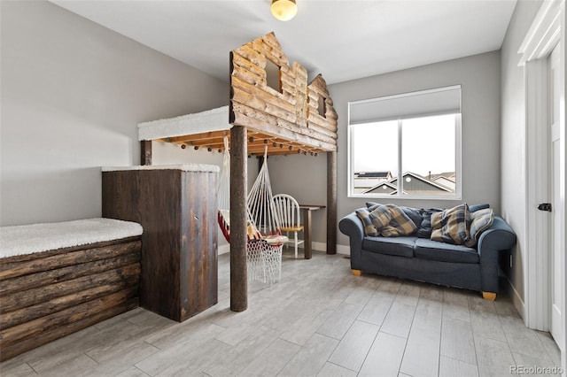 bedroom featuring baseboards and wood finished floors