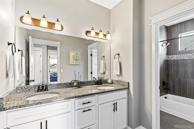 bathroom featuring tile patterned floors,  shower combination, double vanity, and a sink