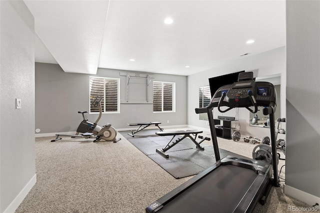 exercise room with baseboards, a wealth of natural light, and recessed lighting