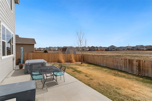 view of patio / terrace featuring a fenced backyard, a residential view, and outdoor dining area