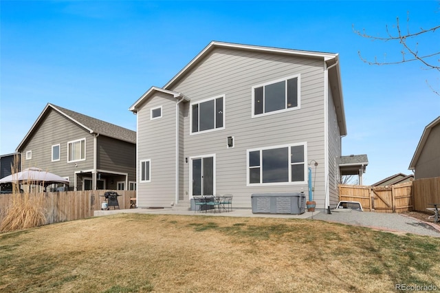 back of house featuring a patio, fence, and a lawn
