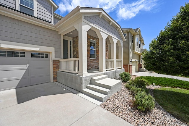 19659 W 59th Dr, Golden, CO 80403 - view of front of house with covered porch, an attached garage, stone siding, and brick siding