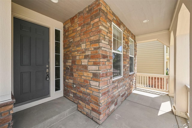 19659 W 59th Dr, Golden, CO 80403 - view of exterior entry with covered porch and brick siding