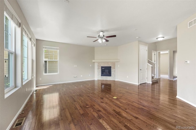 19659 W 59th Dr, Golden, CO 80403 - unfurnished living room with dark wood-type flooring, a ceiling fan, a fireplace, and stairway