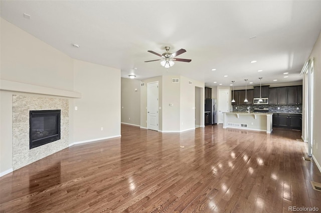 19659 W 59th Dr, Golden, CO 80403 - unfurnished living room featuring a ceiling fan, dark wood-style floors, recessed lighting, and a tile fireplace