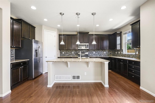 19659 W 59th Dr, Golden, CO 80403 - kitchen featuring stainless steel appliances, an island with sink, tasteful backsplash, dark wood-style floors, and recessed lighting