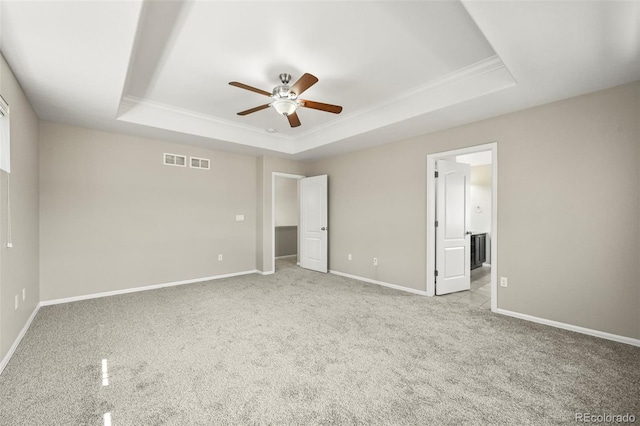 19659 W 59th Dr, Golden, CO 80403 - unfurnished bedroom featuring a tray ceiling, ornamental molding, carpet floors, a ceiling fan, and ensuite bathroom