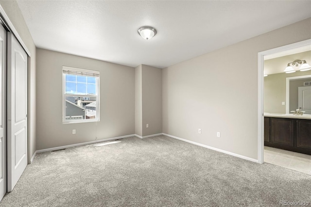 19659 W 59th Dr, Golden, CO 80403 - unfurnished bedroom featuring light colored carpet, connected bathroom, and a closet