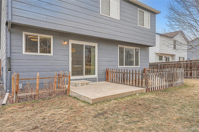 rear view of house featuring a patio area, fence, and a yard