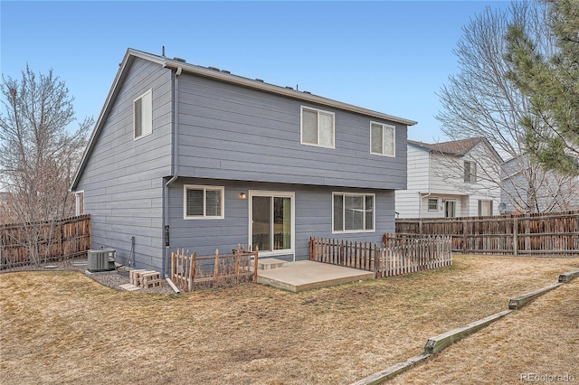 rear view of house with central AC, a yard, a patio area, and a fenced backyard