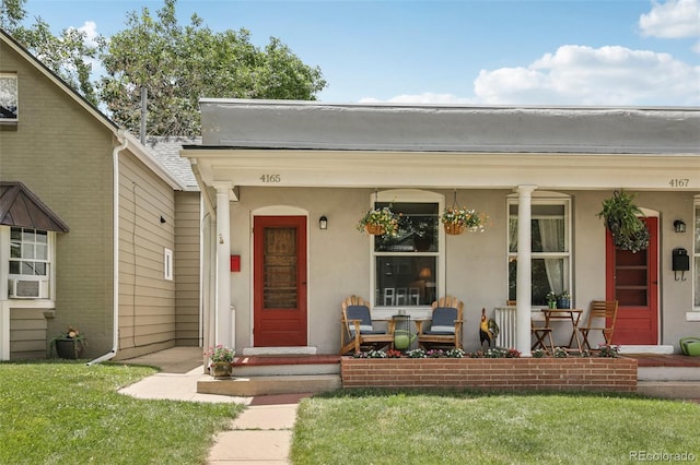 4165 Winona Ct, Denver, CO 80212 - entrance to property featuring a porch, a lawn, and stucco siding