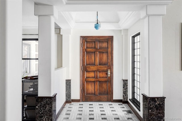 foyer entrance featuring ornamental molding, baseboards, and a healthy amount of sunlight