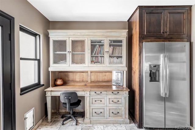 home office featuring built in desk, baseboards, and a healthy amount of sunlight